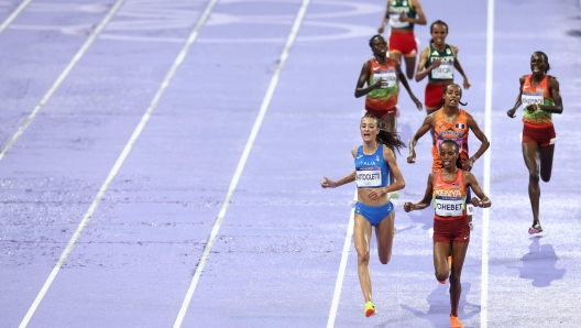 Kenya's Beatrice Chebet and Italy's Nadia Battocletti lead in the women's 10000m final of the athletics event at the Paris 2024 Olympic Games at Stade de France in Saint-Denis, north of Paris, on August 9, 2024. (Photo by Anne-Christine POUJOULAT / AFP)