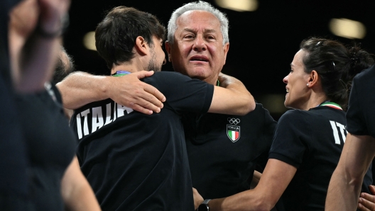 Italy's head coach Julio Velasco and staff celebrate after winning the women's volleyball gold medal match between USA and Italy at the South Paris Arena 1 in Paris during the Paris 2024 Olympic Games on August 11, 2024. (Photo by Patricia DE MELO MOREIRA / AFP)