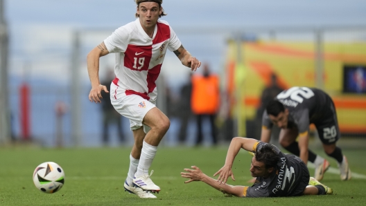 North Macedonia's Stefan Ashkovski, right, is fouled by Croatia's Borna Sosa, left, during the international friendly soccer match between Croatia and North Macedonia at Rujevica stadium in Rijeka, Croatia, Monday, June 3, 2024. (AP Photo/Darko Bandic)