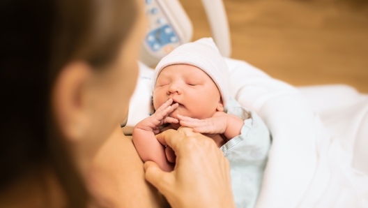 New born baby in hospital bed, child birth, and new life concept.