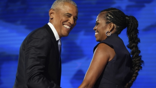 Former President Barack Obama hugs former first lady Michelle Obama as he is introduced during the Democratic National Convention Tuesday, Aug. 20, 2024, in Chicago. (AP Photo/Erin Hooley)