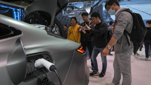 FILE - Visitors look at a Geely Galaxy E8 EV car model during the Auto China 2024 in Beijing on April 28, 2024. (AP Photo/Andy Wong, File)