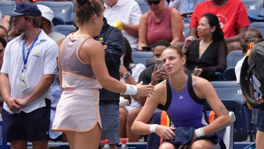 Czech Republic's Karolina Pliskova (R) speak with Italy's Jasmine Paolini while retiring from her women's singles second round tennis match with an injured foot on day four of the US Open tennis tournament at the USTA Billie Jean King National Tennis Center in New York City, on August 29, 2024. (Photo by TIMOTHY A. CLARY / AFP)