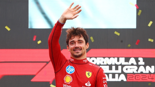 MONZA, ITALY - SEPTEMBER 01: Race winner Charles Leclerc of Monaco and Ferrari celebrates on the podium during the F1 Grand Prix of Italy at Autodromo Nazionale Monza on September 01, 2024 in Monza, Italy. (Photo by Clive Rose/Getty Images)