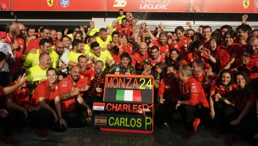 Ferrari driver Charles Leclerc of Monaco celebrates with his teammate Ferrari driver Carlos Sainz of Spain in the Ferrari garage after winning the Italy's Formula One Grand Prix at the Monza racetrack, in Monza, Italy, Sunday, Sep.1, 2024 (AP Photo/Luca Bruno)