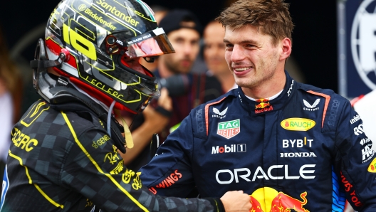 MONZA, ITALY - SEPTEMBER 01: Max Verstappen of the Netherlands and Oracle Red Bull Racing congratulates Race winner Charles Leclerc of Monaco and Ferrari in parc ferme during the F1 Grand Prix of Italy at Autodromo Nazionale Monza on September 01, 2024 in Monza, Italy. (Photo by Mark Thompson/Getty Images)