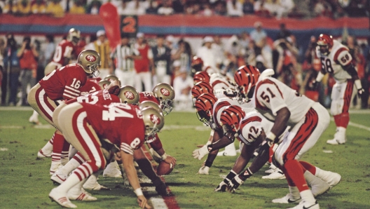 Joe Montana #16, Quarterback for the San Francisco 49ers  calls the play on the line of scrimmage during the National Football League Super Bowl XXIII game against the Cincinnati Bengals on 22 January 1989 at the Joe Robbie Stadium, Miami, Florida, United States. The 49ers won the game 20 - 16.  (Photo by Rick Stewart/Allsport/Getty Images)