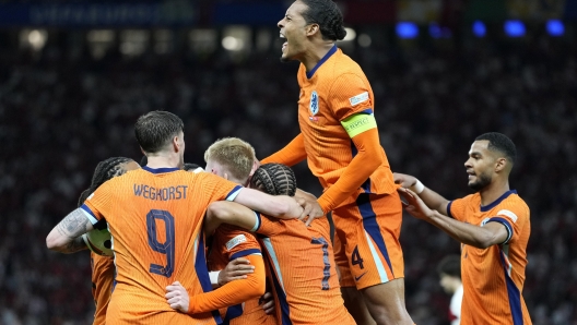 Virgil van Dijk of the Netherlands, up, celebrates after Stefan de Vrij of the Netherlands scored their sides first goal during a quarterfinal match between the Netherlands and Turkey at the Euro 2024 soccer tournament in Berlin, Germany, Saturday, July 6, 2024. (AP Photo/Antonio Calanni)