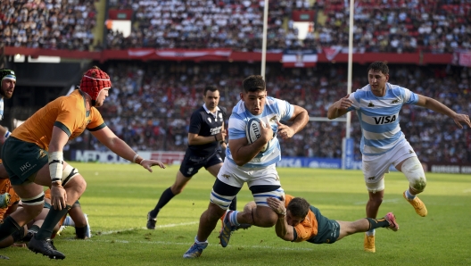 Argentina's Los Pumas Joaquin Oviedo, center, is tackled by Australia's Jake Gordon during a rugby championship test match in Santa Fe, Argentina, Saturday, Sept. 7, 2024. (AP Photo/Mateo Occhi)