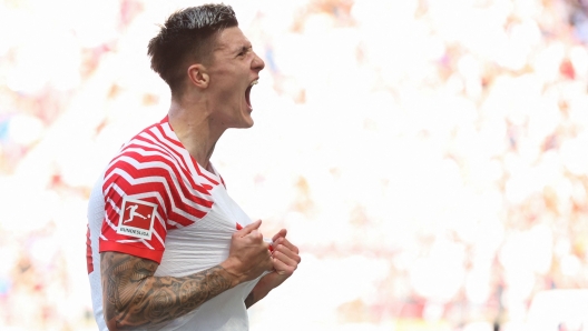 Leipzig's Slovenian forward #30 Benjamin Sesko celebrates scoring during the German first division Bundesliga football match between RB Leipzig and Werder Bremen in Leipzig, eastern Germany on May 11, 2024. (Photo by Ronny HARTMANN / AFP) / DFL REGULATIONS PROHIBIT ANY USE OF PHOTOGRAPHS AS IMAGE SEQUENCES AND/OR QUASI-VIDEO