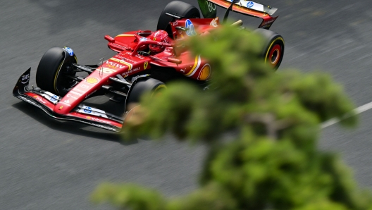 Ferrari's Monegasque driver Charles Leclerc steers his car during the first practice session ahead of the Formula One Azerbaijan Grand Prix at the Baku City Circuit in Baku on September 13, 2024. (Photo by Andrej ISAKOVIC / AFP)