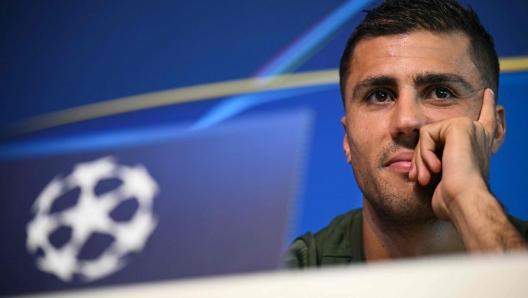 Manchester City's Spanish midfielder #16 Rodri reacts during a press conference at the Manchester City's training ground, in Manchester, north-west England, on September 17, 2024, on the eve of their UEFA Champions League football match against Inter Milan. (Photo by Oli SCARFF / AFP)