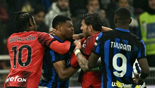 AC Milan's French defender #19 Theo Hernandez (C-R)) fights with Inter Milan's Dutch defender #02 Denzel Dumfries (2C-L) during the Italian Serie A football match between AC Milan and Inter Milan at the San Siro Stadium in Milan on April 22, 2024. (Photo by GABRIEL BOUYS / AFP)