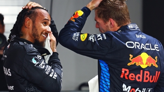 SINGAPORE, SINGAPORE - SEPTEMBER 21: Third placed qualifier Lewis Hamilton of Great Britain and Mercedes interacts with Second placed qualifier Max Verstappen of the Netherlands and Oracle Red Bull Racing in parc ferme during qualifying ahead of the F1 Grand Prix of Singapore at Marina Bay Street Circuit on September 21, 2024 in Singapore, Singapore. (Photo by Mark Thompson/Getty Images)