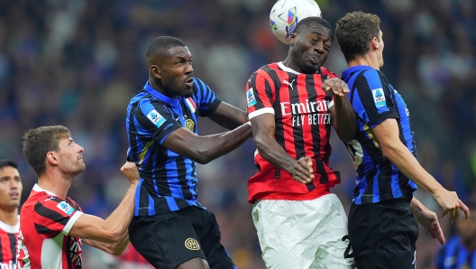 AC Milan's Youssouf Fofana ight for the ball with Inter Milan's Marcus Thuram during the Serie A soccer match between Inter and Milan at the San Siro Stadium in Milan, north Italy - Sunday, September  22 , 2024. Sport - Soccer . (Photo by Spada/Lapresse)