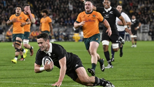 New Zealand's Will Jordan scores a try during their Rugby Championship match between the All Blacks and the Wallabies in Wellington, New Zealand, Saturday, Sept. 28, 2024.(Andrew Cornaga/Photosport via AP)