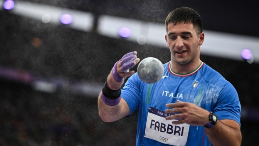 Italy's Leonardo Fabbri competes in the men's shot put final of the athletics event at the Paris 2024 Olympic Games at Stade de France in Saint-Denis, north of Paris, on August 3, 2024. (Photo by Ben STANSALL / AFP)