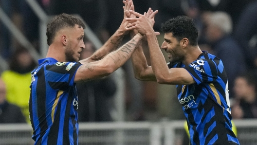 Inter Milan's Marko Arnautovic, left, celebrates with Inter Milan's Mehdi Taremi after scoring his side's second goal during the Champions League opening phase soccer match between Inter Milan and Red Star, at the San Siro stadium in Milan, Italy, Tuesday, Oct. 1, 2024. (AP Photo/Luca Bruno)