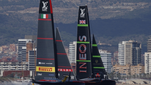 INEOS Britannia, right, and Luna Rosa Prada Pirelli sailing teams compete during the Louis Vuitton Cup Final Day 7 at the Barcelona's coast, Spain, Friday, Oct. 4, 2024. (AP Photo/Joan Monfort)