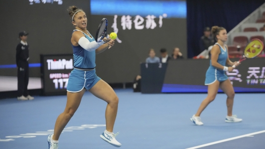 Jasmine Paolini and Sara Errani, left, of Italy play against Chan Hao-Ching of Taiwan and Veronika Kudermetova of Russia during the women's doubles final match at the China Open tennis tournament at the National Tennis Center in Beijing, Sunday, Oct. 6, 2024. (AP Photo/Achmad Ibrahim)