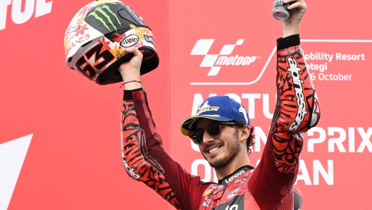 TOPSHOT - Ducati Lenovo Team rider Francesco Bagnaia of Italy celebrates his victory on the MotoGP class race podium of MotoGP Japanese Grand Prix at the Mobility Resort Motegi in Motegi, Tochigi prefecture on October 6, 2024. (Photo by Toshifumi KITAMURA / AFP)