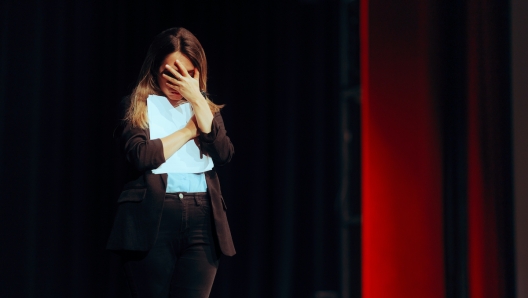 Stressed businesswoman making mistakes on her presentation