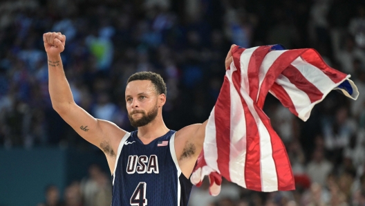 USA's #04 Stephen Curry celebrates after the USA won the men's Gold Medal basketball match between France and USA during the Paris 2024 Olympic Games at the Bercy  Arena in Paris on August 10, 2024. (Photo by Damien MEYER / AFP)