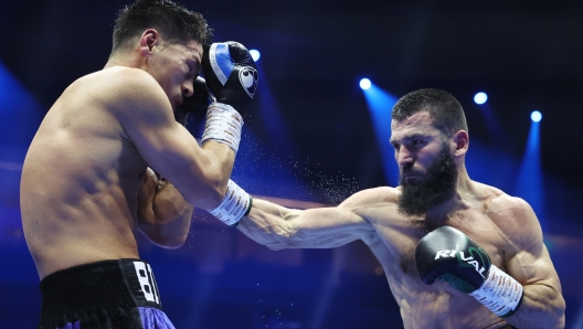 RIYADH, SAUDI ARABIA - OCTOBER 12: Artur Beterbiev punches Dmitrii Bivol during the IBF, IBO, WBC and WBO World Light Heavyweight titles' fight between Artur Beterbiev and Dmitrii Bivol as part of the Riyadh Season - IV Crown Showdown card at Kingdom Arena on October 12, 2024 in Riyadh. (Photo by Richard Pelham/Getty Images)