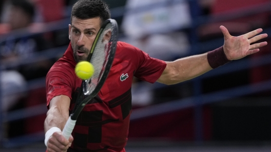 Novak Djokovic of Serbia returns a shot against Jannik Sinner of Italy during the men's singles finals match in the Shanghai Masters tennis tournament at Qizhong Forest Sports City Tennis Center in Shanghai, China, Sunday, Oct. 13, 2024. (AP Photo/Andy Wong)