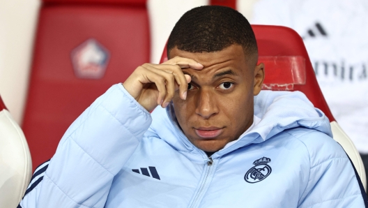 (FILES) Real Madrid's French forward #09 Kylian Mbappe looks on from the bench during the UEFA Champions League football match between Lille LOSC and Real Madrid at the Pierre Mauroy Stadium in Villeneuve-d'Ascq, northern France, on October 2, 2024. Kylian Mbappe is being investigated for rape by Swedish police, according to a newspaper report in Sweden following a visit by the Real Madrid star to Stockholm, which Mbappe denounced as "fake news". (Photo by Sameer AL-DOUMY / AFP)