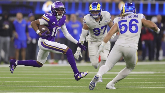 Minnesota Vikings wide receiver Justin Jefferson (18) runs with the ball as Los Angeles Rams linebackers Michael Hoecht (97) and Christian Rozeboom (56) try to tackle him during the second half of an NFL football game, Thursday, Oct. 24, 2024, in Inglewood, Calif. (AP Photo/Ryan Sun)