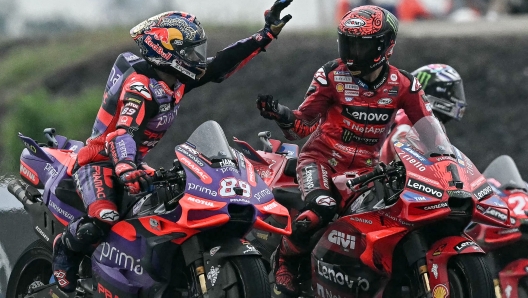 Race winner Ducati Lenovo Team's Italian rider Francesco Bagnaia (R) is greeted by second place Prima Pramac Racing's Spanish rider Jorge Martin (L) after the MotoGP Thailand Grand Prix at the Buriram International Circuit in Buriram on October 27, 2024. (Photo by Lillian SUWANRUMPHA / AFP)