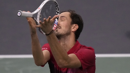 Russia's Daniil Medvedev throws his racket as he plays Alexei Popyrin, of Australia, during their second round match of the Paris Masters tennis tournament, Wednesday, Oct. 30, 2024 in Paris. (AP Photo/Michel Euler)