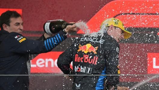 Red Bull's technical director Pierre Wache sprays champagne on Red Bull Racing's Dutch driver Max Verstappen at the podium of the Formula One Sao Paulo Grand Prix, at the Jose Carlos Pace racetrack, aka Interlagos, in Sao Paulo, Brazil, on November 3, 2024. (Photo by NELSON ALMEIDA / AFP)