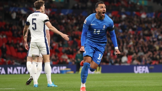 LONDON, ENGLAND - OCTOBER 10: Vangelis Pavlidis of Greece celebrates scoring his team's first goal as he holds his black armband in honour of the passing of former Greek football player George Baldock during the UEFA Nations League 2024/25 League B Group B2 match between England and Greece at Wembley Stadium on October 10, 2024 in London, England. (Photo by Julian Finney/Getty Images)