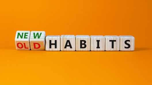 New or old habits symbol. Turned wooden cubes, changed words 'old habits' to 'new habits'. Beautiful orange table, orange background. Business, old or new habits concept. Copy space.