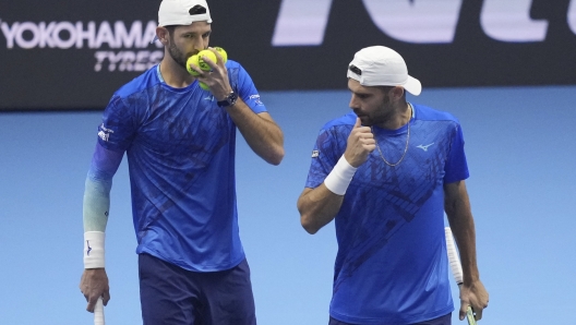 Italy's Simone Bolelli and Andrea Vavassori talk during their doubles tennis match of the ATP World Tour Finals against India's Rohan Bopanna and Australia's Matthew Ebden, at the Inalpi Arena, in Turin, Italy, Monday, Nov. 11, 2024. (AP Photo/Antonio Calanni)