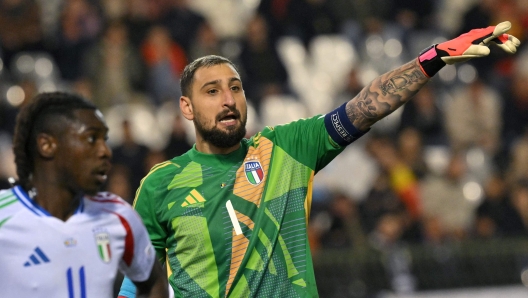 Italy's goalkeeper #01 Gianluigi Donnarumma gestures during the UEFA Nations League Group A2 football match between Belgium and Italy at the King Baudouin Stadium in Brussels on November 14, 2024. (Photo by NICOLAS TUCAT / AFP)