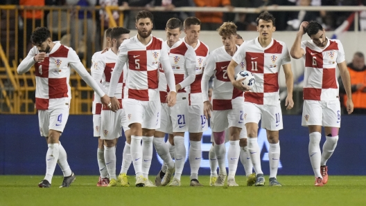 Croatia players celebrate their side's equalizer, scored by Croatia's Josko Gvardiol, left, during the UEFA Nations League soccer match between Croatia and Portugal at Poljud stadium in Split, Croatia, Monday, Nov. 18, 2024. (AP Photo/Darko Bandic)