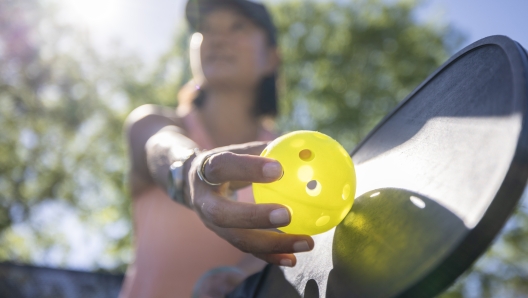 A woman having fun and playing pickleball