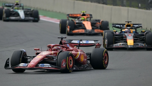 Ferrari's Monegasque driver Charles Leclerc races in front of Red Bull Racing's Dutch driver Max Verstappen, McLaren's British driver Lando Norris and Mercedes' British driver Lewis Hamilton during the Mexico City Grand Prix at the Hermanos Rodriguez racetrack, in Mexico City on October 27, 2024. (Photo by YURI CORTEZ / AFP)