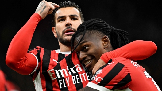 AC Milan's French defender #19 Theo Hernandez celebrates with AC Milan's Portuguese forward #10 Rafael Leao (R) after scoring the opening goal during the Italian Serie A football match between AC Milan and Venezia FC at the San Siro Stadium in Milan, on September 14, 2024.  (Photo by Gabriel BOUYS / AFP)