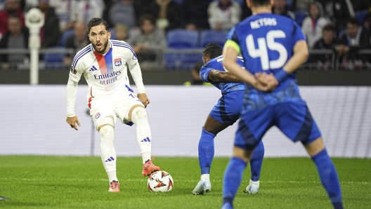 Lyon's Rayan Cherki, left, controls the ball during the Europa League opening phase soccer match between Lyon and Olympiacos at Decines stadium outside Lyon, France, Thursday, Sept. 26, 2024. (AP Photo/Laurent Cipriani)