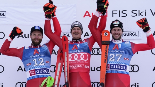 From left, second placed Austria's Marco Schwarz, the winner Austria's Manuel Feller and third placed Michael Matt celebrate on podium after an alpine ski, men's World Cup slalom in Gurgl, Austria, Saturday, Nov. 18, 2023. (AP Photo/Piermarco Tacca)   Associated Press/LaPresse Only Italy and Spain