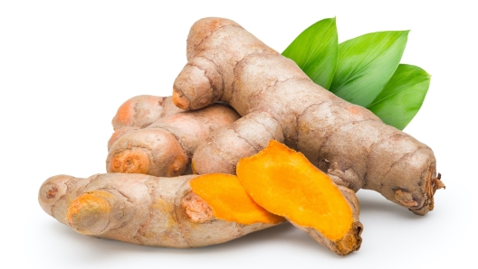 Fresh Turmeric (Curcuma longa) with the leaf on white background. Commercial image of medicinal plant isolated with clipping path.