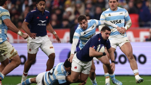 France's fly-half Thomas Ramos is tackled during the Autumn Nations Series international rugby union test match between France and Argentina at the Stade de France in Saint-Denis, north of Paris, on November 22, 2024. (Photo by Anne-Christine POUJOULAT / AFP)