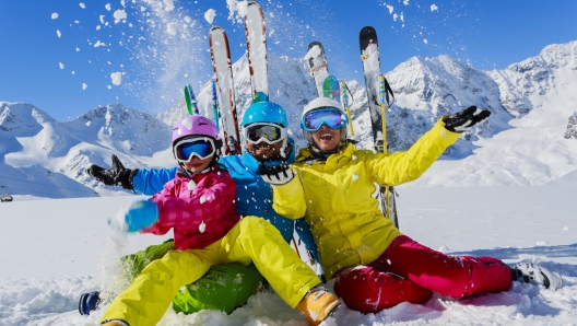 Skiing, winter, snow,  skiers, sun and fun - family enjoying winter vacations