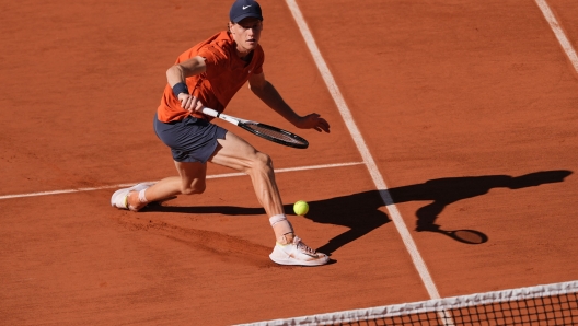 Italy's Jannik Sinner plays a backhand return to Spain's Carlos Alcaraz during their men's singles semi final match on Court Philippe-Chatrier on day thirteen of the French Open tennis tournament at the Roland Garros Complex in Paris on June 7, 2024. (Photo by Dimitar DILKOFF / AFP)