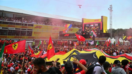 Supporters and Ferrari's fans celebrate Ferrari's Monegasque driver Charles Leclerc's victory after the Italian Formula One Grand Prix race at Autodromo Nazionale Monza circuit, in Monza on September 1, 2024. (Photo by Andrej ISAKOVIC / AFP)