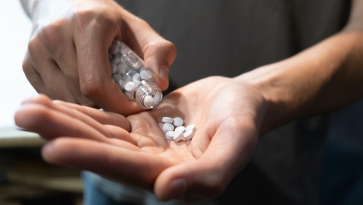 Hand with tablet pills. For treatments, advertising and health care messages